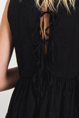 Sleeveless dress with ruffled detail on the side